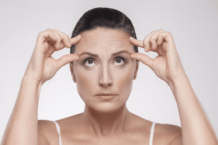 woman-with-perfect-face-skin-checking-wrinkles-her-forehead